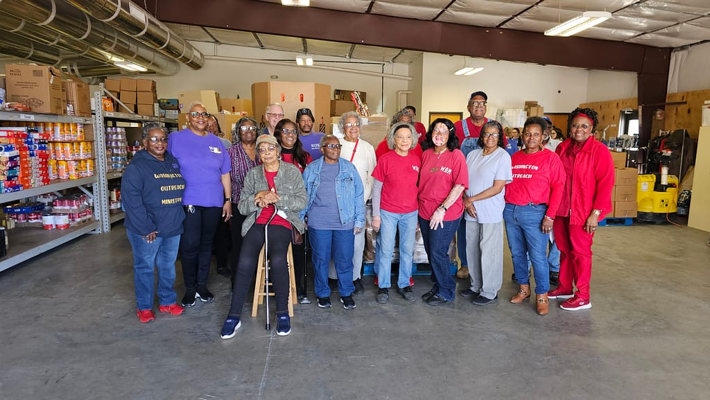 A group of dedicated volunteers in the warehouse at Washington Outreach Ministry